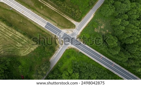 Overhead View of a Busy Crossroad Surrounded by Greenery During Daylight