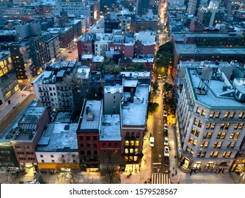 Overhead View Of The Busy Streets Of Nolita And SoHo Neighborhoods With Colorful Night Lights Shining At Dusk In Manhattan, New York City NYC