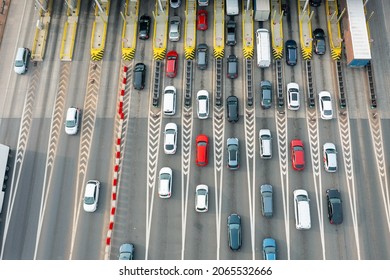 An overhead view of a busy toll road with many cars queuing up to pay the highway toll - Shutterstock ID 2065532666