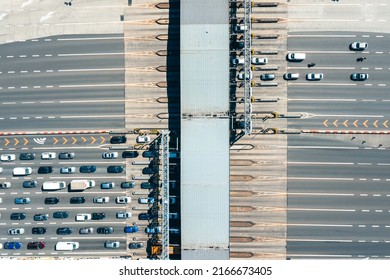 An Overhead View Of A Busy Toll Road With Many Cars Queuing Up To Pay The Highway Toll.