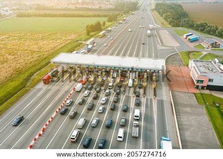 An overhead view of a busy toll road with many cars queuing up to pay the highway toll Stock photo © 