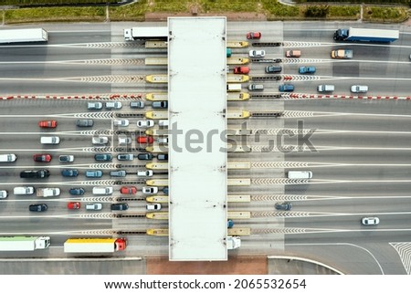 An overhead view of a busy toll road with many cars queuing up to pay the highway toll Stock photo © 