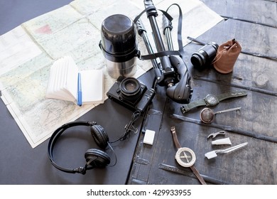 Overhead view of camera, accessories, map and notebook