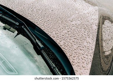 Overhead View Of Car Hood And Front Windshield With Multiple Water Drops On Car New Metallic Paint