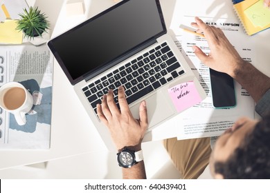 overhead view of casual businessman working on laptop at modern office, business men computer