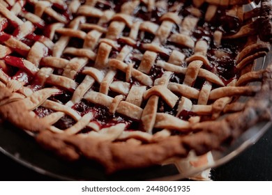 Overhead view of cherry pie served in plate on black table