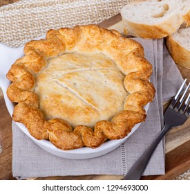 Overhead View Of A Chicken Pot Pie With Golden Crust In A White Baking Dish