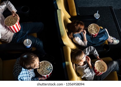 Overhead View Of Children In 3d Glasses Eating Paper Cup In Cinema 