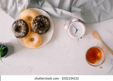 Overhead View Of Chocolate Cake Donuts With Salted Caramel Glaze With A Cup Of Espresso On Marble Table Top. Afternoon Me Time Book Reading With Dessert And Coffee. Text Space Images