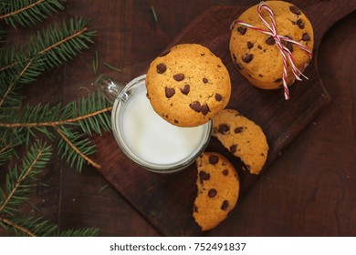 Overhead View Of Chocolate Chip Cookies And Milk On Dark Wooden Background