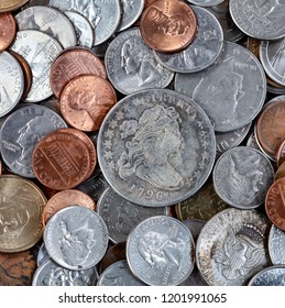 Overhead View Of Coins With Rare One In Middle Of Pile 