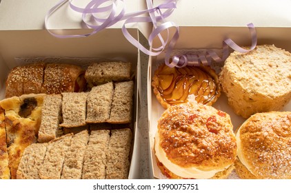 Overhead View Of The Contents Of An Afternoon Tea Box Delivered To A Home During The Covid Pandemic