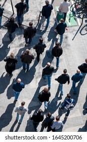 Overhead View Of Crowd Of Unrecognizable Pedestrians Walking On Sidewalk