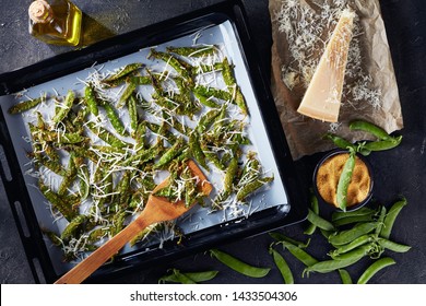 Overhead View Of Crunchy Baked Parmesan Sugar Snap Peas In A Baking Pan On A Concrete Table With Ingredients, View From Above, Flatlay