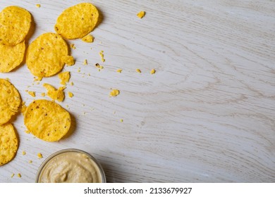 Overhead View Of Crunchy Chips With Dip In Bowl On Table With Empty Space. Unaltered, Copy Space, Unhealthy Food, Snack, Dipping Sauce, Crunchy And Savory Food.