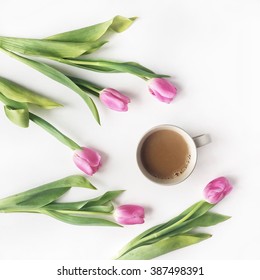 Overhead View Of Cup Of Coffee With Milk And Pink Tulips Isolated On White Background. Flat Lay, Top View