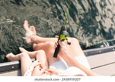 Overhead view of Dad and girl fishing off dock - Powered by Shutterstock