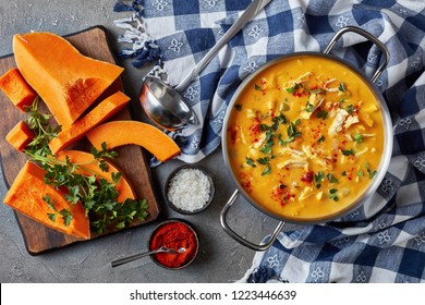 Overhead View Of Delicious Butternut Squash Chicken Breast Creamy Soup In A Metal Casserole On A Concrete Table With Kitchen Towel,sliced Squash And Spices, View From Above, Flat Lay