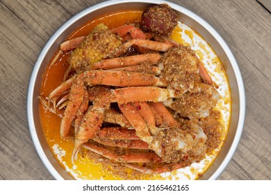 Overhead View Of Delicious Buttery Seasoned Snow Crab Legs With Corn On The Cob For A Great Seafood Boil.