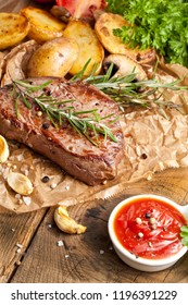 Overhead View Of Delicious,grilled Beef Steak With Roasted Potatoes And Fresh Green Herb Salad On An Old Wooden Table