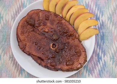 Overhead View From Directly Above Of A Ham Steak On A Platter, Glazed With Peach Preserves And Garnished With Peach Slices