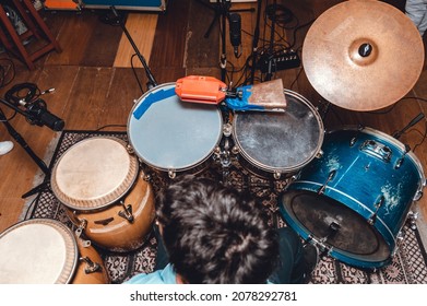 Overhead View Of A Drummer Playing Latin Music On An Acoustic Drum Kit And Congas, With Microphones In A Professional Recording Studio. Music Industry Concept.