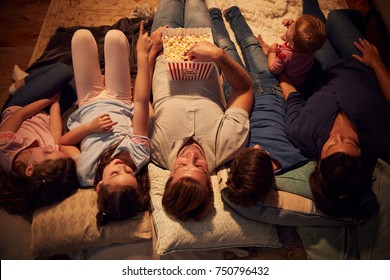 Overhead View Of Family Enjoying Movie Night At Home Together