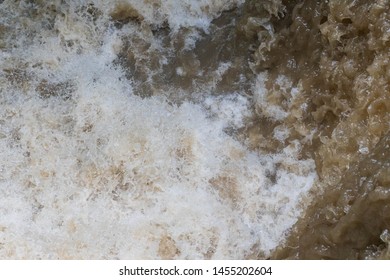 Overhead View Of Fast Flowing Brown Water In Flooding Event