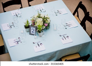 Overhead View Of A Floral Centerpiece On A Square Table At A Formal Event