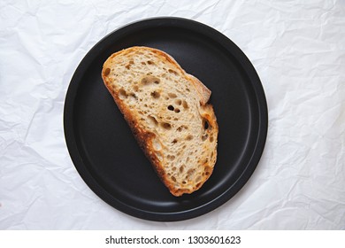 Overhead View Of Fresh Bread / Sourdough Toast On A Black Plate