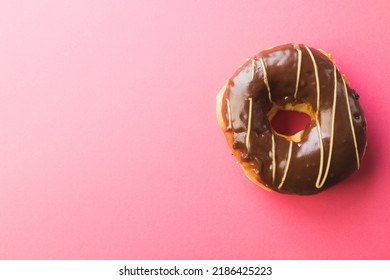 Overhead View Of Fresh Chocolate Donut By Copy Space Against Pink Background. Unaltered, Unhealthy Eating And Sweet Food Concept.