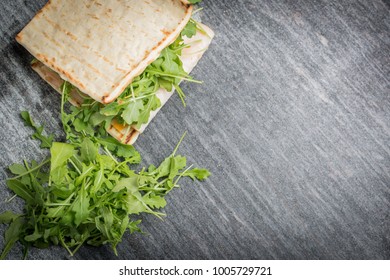 An Overhead View Of A Fresh Deli Sandwich And Salad On A Granite Countertop.