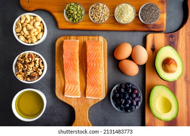 Overhead View Of Fresh Omega-3 Rich Foods: A Variety Of Healthy Foods Like Fish, Nuts, Seeds, Fruit, Vegetables, And Oil Rich In Omega-3 Nutrients