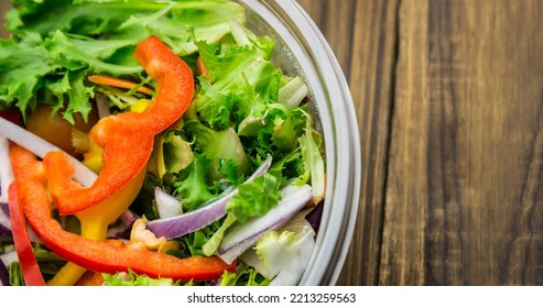 Overhead View Of Fresh Vegetable Salad In Glass Bowl On Wooden Table, Copy Space. Unaltered, Veganism, Organic, Food, Healthy, Support, Vegan Day And Celebration Concept.