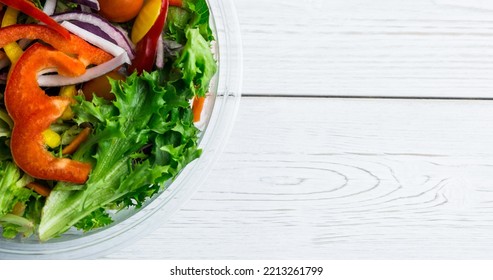 Overhead View Of Fresh Vegetable Salad In Glass Bowl Placed On Wooden Table, Copy Space. Unaltered, Veganism, Organic, Food, Healthy, Support, Vegan Day And Celebration Concept.