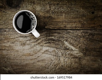 Overhead View Of A Freshly Brewed Mug Of Espresso Coffee On Rustic Wooden Background With Woodgrain Texture And Cracks, With Copyspace