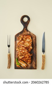 Overhead View Of Fried Chopped Pork Tenderloin On Wooden Cutting Board