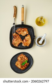 Overhead View Of Fried Chopped Pork Tenderloin On Plate And Pan