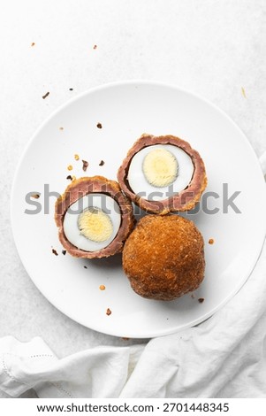 Overhead view of fried scotch egg, top view of cross-section of scotch eggs