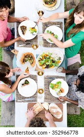 Overhead View Of Friends Passing Food At A Table, Outdoor Garden Lunch Party Celebration