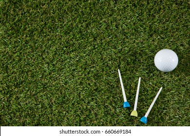 Overhead View Of Golf Ball With Tee On Grassy Field