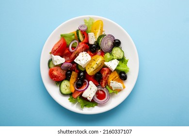 Overhead View Of Greek Salad On Blue Background  Mediterranean Food