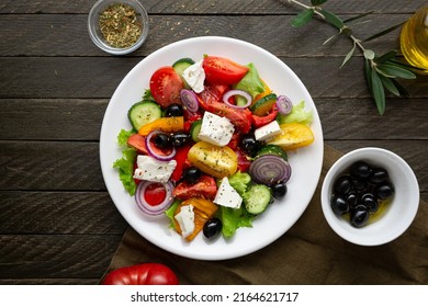 Overhead View Of Greek Salad On Wooden Background 