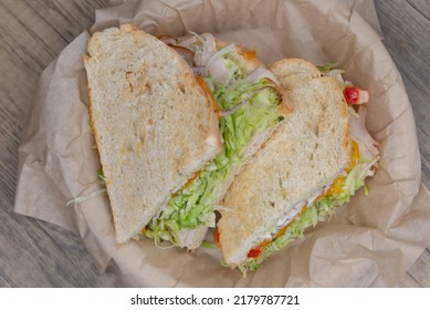 Overhead View Of Grilled Roasted Turkey Sandwich With Meat, Provolone Cheese, And Mayo On Sour Dough Bread.