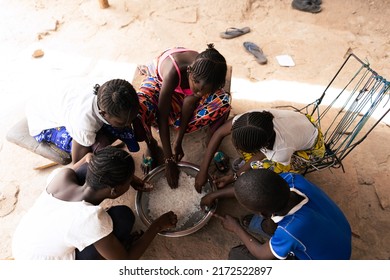 Overhead View Of A Group Of African Village Children Sharing A Simple Meal Of Rice; Malnutrition Concept