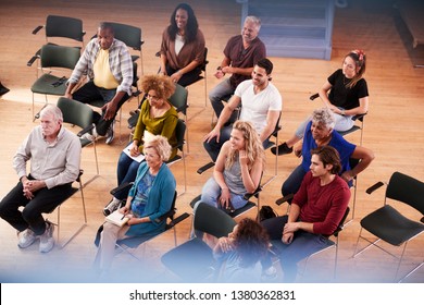 Overhead View Of Group Attending Neighborhood Meeting In Community Center