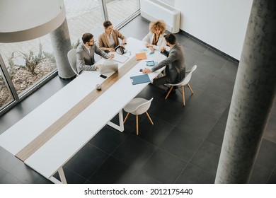 Overhead view at group of multiethnic business people working together in the office - Powered by Shutterstock