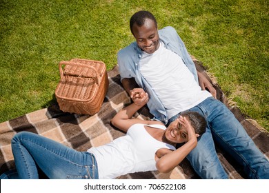 Overhead View Of Happy African American Couple Resting On Blanket Together While Having Picnic