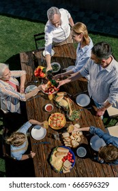 Overhead View Of Happy Family Spending Time Together On Picnic Outdoors