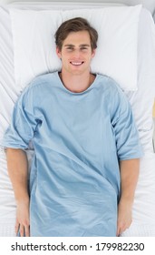 Overhead View Of Happy Male Patient Lying In Hospital Bed